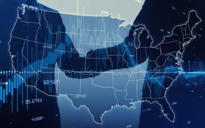 Business handshake overlaid with a digital map of the United States and financial data graphics.