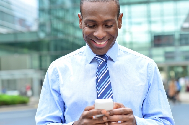 Man holding a phone and smiling